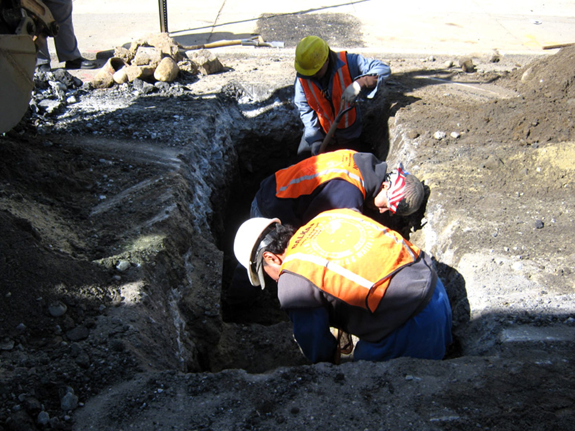 Workers digging in a NYC roadway for a sewer replacement.