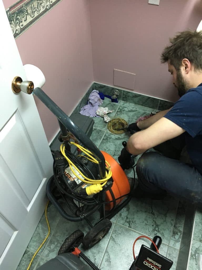 Investigating and snaking a basement floor drain backing up.