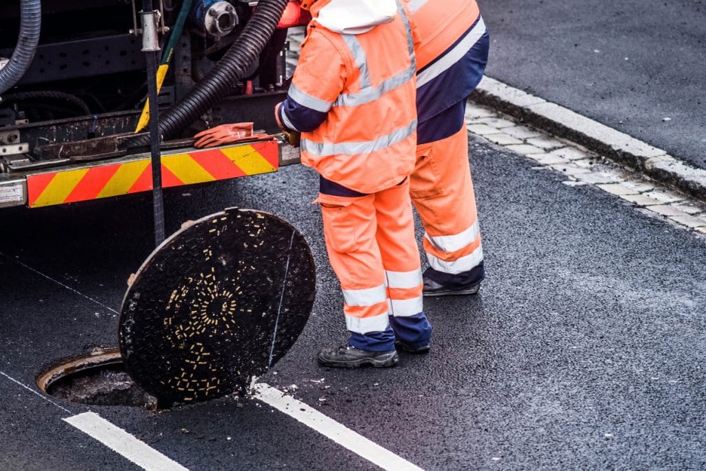 Team of drain cleaning experts attending to a city's complex sewer system.