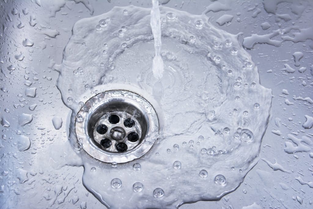 Water draining at a sink showing water flowing clearly.